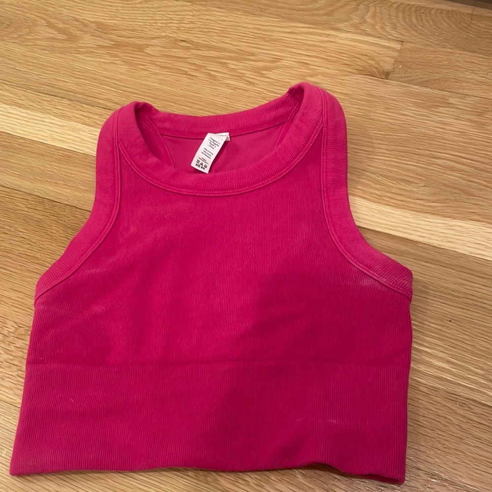 cute pink alo workout top, small deodorant mark but barely noticeable